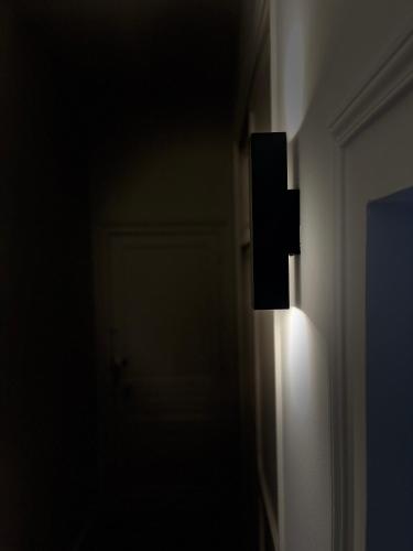 a dark room with a light on the wall at Richard Lequet Domaine gastronomique du Val d Atur in Boulazac