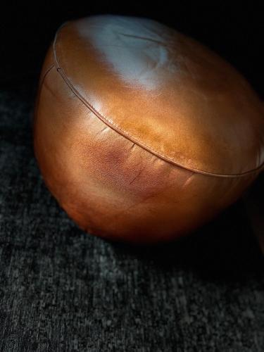 a brown leather ball sitting on the floor at Richard Lequet Domaine gastronomique du Val d Atur in Boulazac