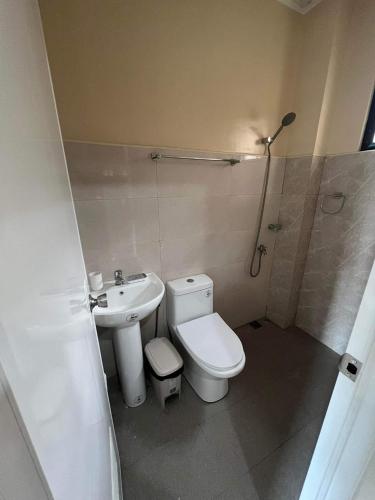 a bathroom with a toilet and a sink and a shower at Eden’s Residence Space Rental in Cagayan de Oro