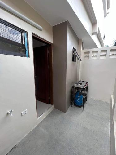 a hallway of a house with a door and a table at Eden’s Residence Space Rental in Cagayan de Oro