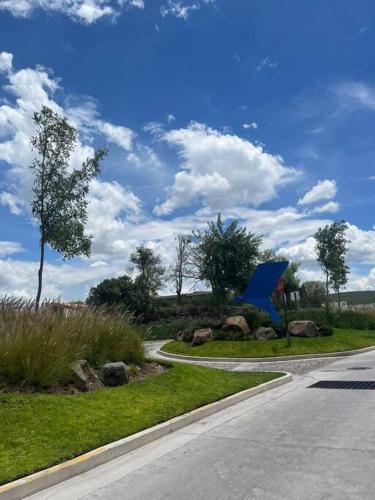 a road with a blue tent on the side of the road at Acogedora casa in Querétaro