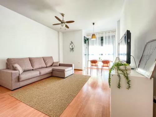 a living room with a couch and a table at Apartamento Cerca del Mar y aeropuerto in Alicante