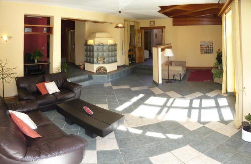 a living room with leather couches and a table at Rosenhof in Ebensee