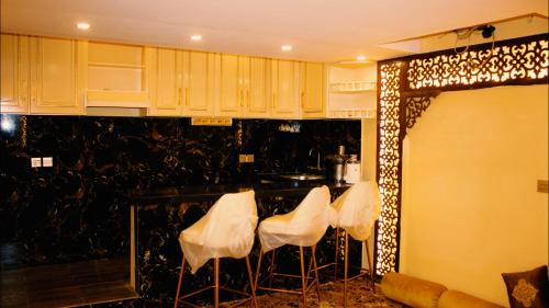 a group of white stools in a room at The Zabeel Palace Villa in Karachi