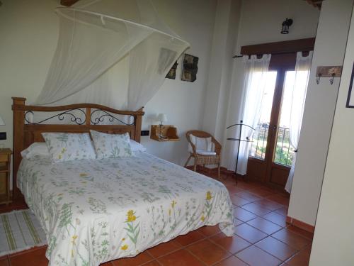 a bedroom with a bed with a canopy at Altillo del Aravalle in Umbrías