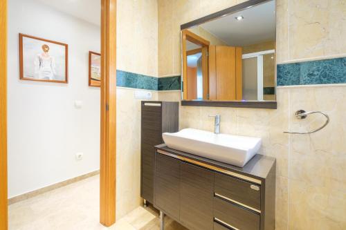 a bathroom with a sink and a mirror at Acintur Apartment Levante Beach-Old Town in Benidorm