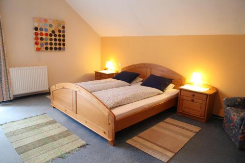 a bedroom with a bed with two lamps on it at Rosenhof in Ebensee