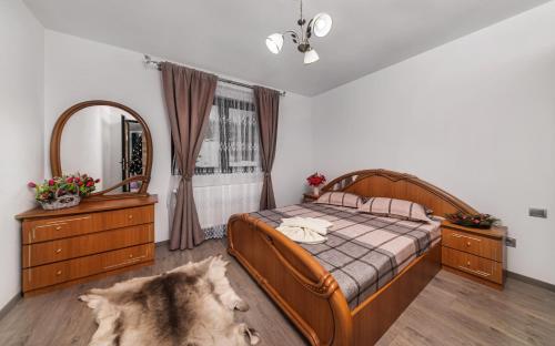 1 dormitorio con 1 cama grande y espejo grande en Casa Mariteo Colibita, en Colibiţa