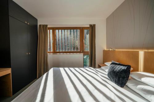 a bedroom with a large bed and a window at ENDEMIT Boutique Hotel & Spa in Horní Bečva