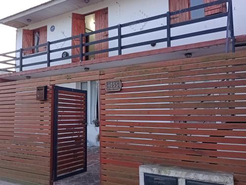 a wooden building with a door and a balcony at Sáenz Faro in Mar del Plata