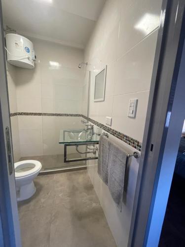 a bathroom with a toilet and a sink with towels at Ana rent in Boulogne