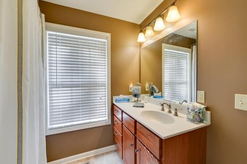 a bathroom with a sink and a mirror at Lakefront Gilbertville Haven with Private Boat Dock! in Gilbertsville