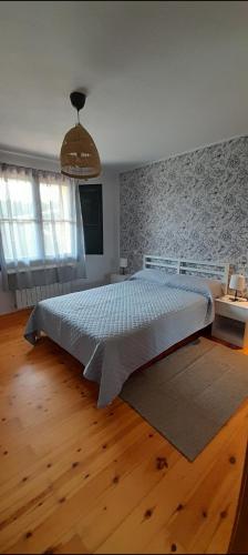 a bedroom with a large bed in a room at El Acebu in Colombres