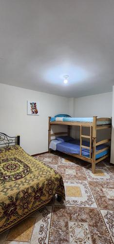 a bedroom with two bunk beds and a tile floor at apartamento para turistas Solangel in San Gil