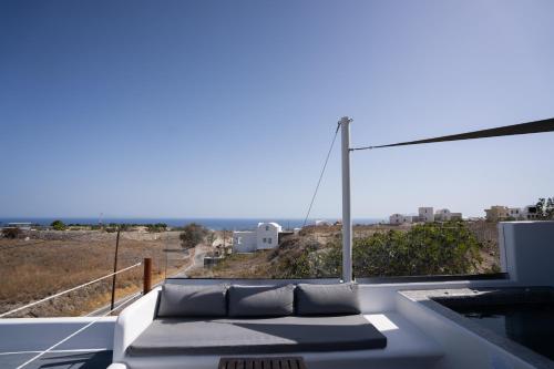 a couch on a balcony with a view of the ocean at Griseo Villas in Karterados