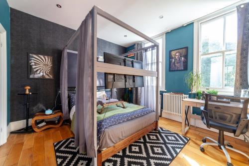 1 dormitorio con litera y escritorio en Master En - Suite Townhouse double with Garden & Hot Tub, en Londres