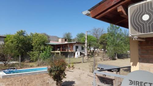 dom z basenem przed nim w obiekcie POSADA LAS MARGARITAS w mieście Santa Rosa de Calamuchita