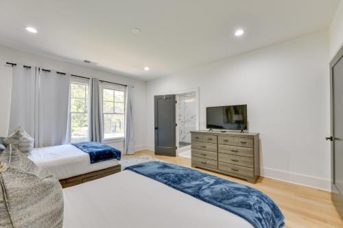 a bedroom with a large bed and a television at Luxe Townhome in South End Charlotte Near Uptown! in Charlotte