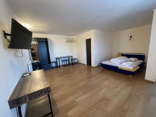 a room with a bed and a desk in it at Спортохота in Cherkasy