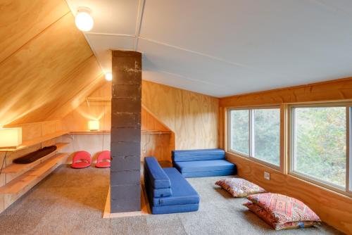 a living room with wood paneling and a fireplace in a house at Charming Putney Home Porch, Grill and Hiking Trails in Putney