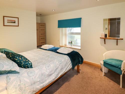 a bedroom with a bed and a window at The Granary in Biddulph