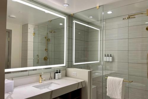 a bathroom with a sink and a glass shower at Elegant Stay at Resorts World Strip Las Vegas in Las Vegas