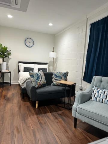 a living room with a couch and a bed at 1BR Fully Handicap Accessible Near Downtown in Greenville