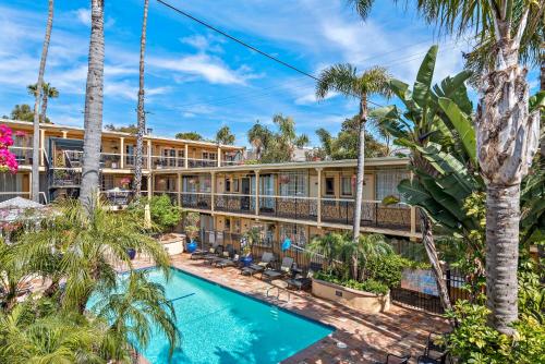 an exterior view of a resort with a swimming pool and palm trees at 14 West Laguna Beach in Laguna Beach