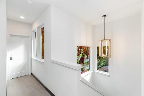 a hallway with white walls and windows in a house at Bobba Fett's Carbonite Suite in Seattle