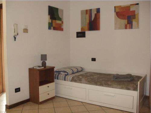 - une chambre avec un lit et des peintures murales dans l'établissement Foresteria Casa Dante, à Leno