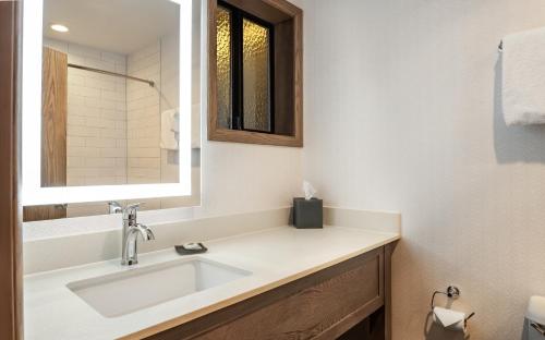 a bathroom with a sink and a mirror at Gold Beach Inn in Gold Beach