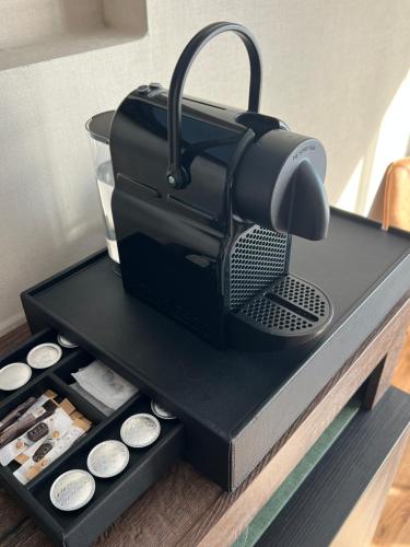 a black coffee maker sitting on top of a table at Gemütliches Studio im Stadtkern mit Kanalblick in Emden