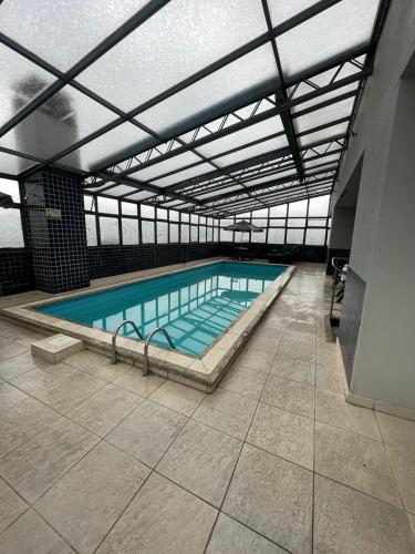 a large swimming pool in a building at Aquarius Flat Studio 601 in Santa Cruz do Sul