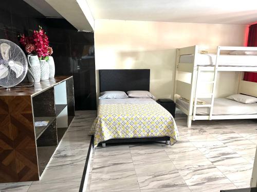 a bedroom with a bed and a desk and bunk beds at Ica Adventures II in Ica