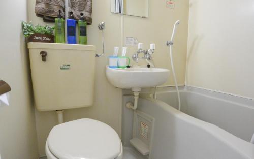 a small bathroom with a toilet and a sink at Carid Shiraishi In front of the station - Vacation STAY 15492 in Sapporo