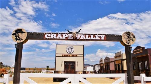 a sign that reads grape valley in front of a building at Grape Valley Old West Cabins in Ensenada