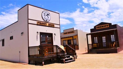 a building with a clock on the front of it at Grape Valley Old West Cabins in Ensenada