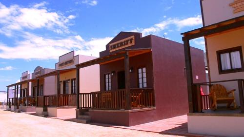 a row of buildings on the side of a street at Grape Valley Old West Cabins in Ensenada