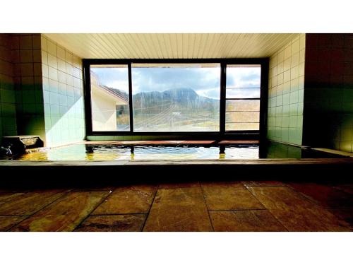 an empty room with a large window in a bathroom at Hotel & Onsen 2307 Shigakogen - Vacation STAY 72767v in Shiga Kogen