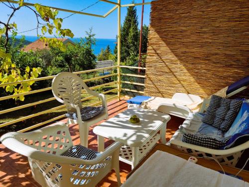 a patio with chairs and a table and an umbrella at Summer house Kruce in Kruče