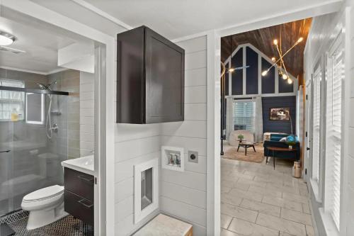 a bathroom with a toilet and a shower and a sink at Tiny Victorian built on TV show 2br 1 ba in Gainesville