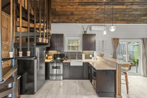 a kitchen with wood ceilings and a wooden ceiling at Tiny Victorian built on TV show 2br 1 ba in Gainesville