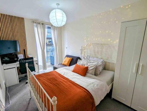 a bedroom with a large bed with an orange blanket at Canal Room in London