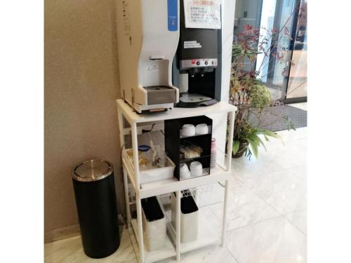 a white shelf with a coffee maker on it at QUEEN'S HOTEL CHITOSE - Vacation STAY 67739v in Chitose