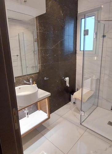 a bathroom with a sink and a shower and a toilet at Smart Living-2Bed Pallouriotissa, Nicosia in Nicosia