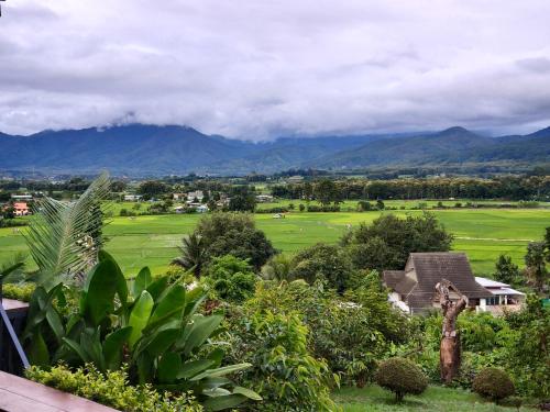 a view of a golf course with mountains in the background at นะลาวิว รีสอร์ท ปัว Nala View Resort Pua in Pua