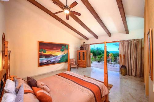 a bedroom with a bed and a ceiling fan at Sea Treasure Villa in Puerto Vallarta