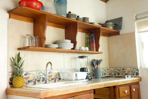 a kitchen with a sink and a counter top at LALORA Hotel & Villas in San Patricio Melaque