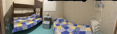 a room with two beds and a bunk bed at B&B Patagonia Dreams in Puerto Montt