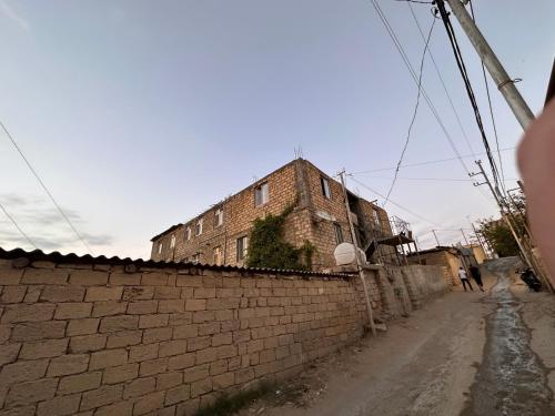 an old brick building on the side of a street at Sovet Hostel in Baku